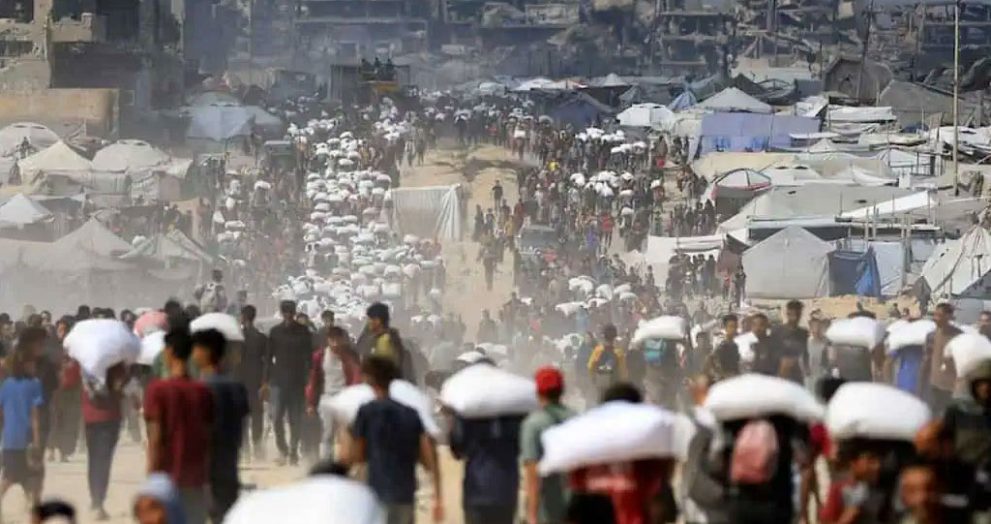 Gaza Crisis: 73 Killed in Aid Chaos as Famine Tightens Grip July 20, 2025 | By ClickUSANews Team Gaza is reeling from a worsening humanitarian disaster, with at least 73 Palestinians killed while seeking aid amid a crippling Israeli siege and rampant food shortages. Reports from Khan Younis describe chaotic scenes of alleged indiscriminate firing by Israeli forces on civilians waiting for food, marking a grim escalation in the region’s hunger crisis. As famine threatens, aid access remains blocked, leaving millions on the edge of survival. Deadly Chaos at Aid Sites Gaza’s Health Ministry reported 59 deaths and hundreds injured in a single day in Khan Younis, where crowds gathered near aid trucks were allegedly fired upon by Israeli troops. Social media footage, yet to be verified, shows bodies strewn across streets, with injuries consistent with heavy weaponry. The Israel Defense Forces (IDF) denied responsibility for the deaths, claiming they fired warning shots to manage crowds they deemed threatening, and are investigating the incident. Since May 2025, the Gaza Humanitarian Foundation (GHF), backed by the U.S. and Israel, has distributed limited aid but faced criticism for operating in militarized zones. Over 800 Palestinians have reportedly died near GHF sites, with witnesses alleging reckless use of force. The UN and humanitarian groups have slammed the setup as unsafe and insufficient, calling for broader, safer aid distribution. Starvation and Blockade Fuel Crisis A near-total blockade, reinstated on March 2, 2025, has choked Gaza’s access to food, fuel, and medical supplies, driving 83% of needed aid to a standstill, per the Norwegian Refugee Council. Residents are surviving on minimal food, with prices skyrocketing by up to 4,000%. The UN’s World Food Programme has shut down community kitchens serving 420,000 people due to depleted stocks. UNRWA, Gaza’s main aid provider, has thousands of trucks ready at the border—enough for 180 million meals—but has been barred from delivery for over four months. The Integrated Food Security Phase Classification (IPC) warns of full-scale famine, with 650,000 children under five facing acute malnutrition. At least 67 children have died from starvation, and 92% of infants and pregnant women lack adequate nutrition. Water shortages, worsened by damaged infrastructure and fuel scarcity, have forced some to resort to seawater. UNRWA and Global Outcry UNRWA, which employs 13,000 staff and handles 80% of Gaza’s aid, has labeled the blockade a “deliberate famine” and demanded immediate access to deliver supplies. The UN Human Rights Office condemned the violence at aid sites as a potential war crime, urging Israel to comply with international humanitarian law. Amnesty International and other groups have accused Israel of using starvation as a tactic, with the International Court of Justice now reviewing Gaza’s aid crisis. Conflict and Collapsed Ceasefire The crisis stems from a collapsed ceasefire in March 2025, following Hamas’s October 7, 2023, attack on Israel, which killed 1,200 and took 251 hostages. Israel’s response has killed over 57,800 Palestinians, mostly women and children, per Gaza’s Health Ministry. Recent IDF operations, including 250 strikes in 48 hours, have displaced 90% of Gaza’s 2.3 million people and crippled infrastructure, leaving only 17 of 36 hospitals partially operational and 1,500 hospital beds available. Ceasefire talks, mediated by the U.S. and Qatar, have stalled over issues like Israeli withdrawal and aid access, prolonging the suffering. Urgent Call for Action Humanitarian agencies are pressing Israel to lift the blockade, open border crossings, and allow UNRWA to deliver aid safely. The UN has called for an immediate ceasefire to avert further deaths from starvation and violence. As Gaza faces an unprecedented crisis, the world is urged to act swiftly to save lives. Follow ClickUSANews for real-time updates on Gaza’s humanitarian emergency. Tags: Gaza crisis, famine, Israeli siege, civilian deaths, UNRWA, Khan Younis, Gaza Humanitarian Foundation, aid blockade Sources: Reuters, BBC, Al Jazeera, UN News, Amnesty International, The Guardian, PBS News